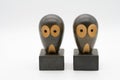 Two Wooden owl bookends with large eyes isolated on a white background