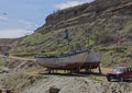 Two wooden Peruvian Fishing Boats propped up on land waiting for some maintenance Royalty Free Stock Photo