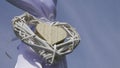 Two wooden rustic decorative hearts hanging on a wedding arch - blue sky in the background