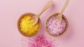 Two Wooden Spoons Filled With Pink and Yellow Sugar