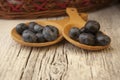 Two wooden spoons with fresh blueberries and wicker basket Royalty Free Stock Photo