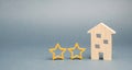 Two wooden stars and a house. Two star hotel or restaurant. Review of the critic. Quality of service and level of service. Rating Royalty Free Stock Photo