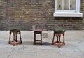 Two wooden stools and a small table Royalty Free Stock Photo