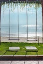 Two wooden swings next to each other are tied to the bar on a sunny morning. Royalty Free Stock Photo