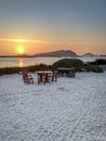 Table and chairs on a beach at sunset Royalty Free Stock Photo