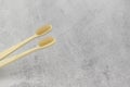 Two wooden toothbrushes on a concrete background Royalty Free Stock Photo