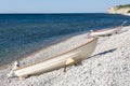 Two wooden boats stretched out on a stony shore near the fjords, a picturesque coastal. Photo taken at HÃÂ¶gklint Gotland Sweden Royalty Free Stock Photo