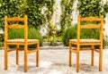 Two wooden and wicker chairs in a nice and courtyard Royalty Free Stock Photo