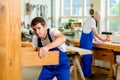 Two worker in a carpenter's workshop Royalty Free Stock Photo