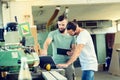 Two worker in a carpenter`s workshop with computer and clipboard Royalty Free Stock Photo