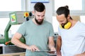 Two worker in a carpenter`s workshop in conversation Royalty Free Stock Photo