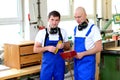 Two worker in a carpenter's workshop Royalty Free Stock Photo