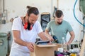 Two worker in a carpenter`s workshop with parcel Royalty Free Stock Photo