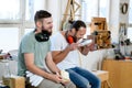 Two worker in a carpenter`s workshop taking a break Royalty Free Stock Photo