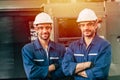 Two worker engineer man standing  arm folding smiling with machine in heavy industry factory Royalty Free Stock Photo