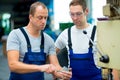 Two worker in factory on the machine Royalty Free Stock Photo