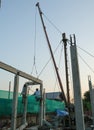 two worker man welding steel concrete pile high house structure in construction site to evening Royalty Free Stock Photo