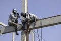 Two worker man welding steel concrete pile high house structure in construction site. labor man working high pile no safety . long Royalty Free Stock Photo