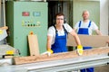 Two worker in workshop using saw machine Royalty Free Stock Photo