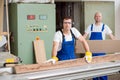 Two worker in workshop using saw machine Royalty Free Stock Photo