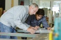 two workers choosing pvc aluminium window profile at stand Royalty Free Stock Photo