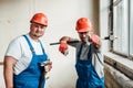 Two workers at a construction site, one points with a finger at the camera Royalty Free Stock Photo