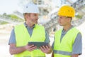 two workers on construction site using tablet Royalty Free Stock Photo