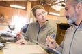 two workers in discussion in workshop