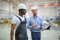 Two workers at a factory for the production of plastic windows. Engineer and worker on the production line Royalty Free Stock Photo