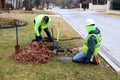 Workers fixing leak on water meter and digging out very wet mud on cold day in Tulsa Oklahoma USA 2 22 2018