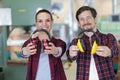 Two workers holding forward pair earmuffs each Royalty Free Stock Photo