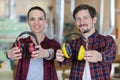 Two workers holding forwards their earmuffs