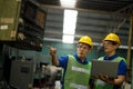 Two workers at an industrial plant with a laptop in hand and document plan, Engineer looking of working at industrial machinery