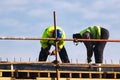 Two Workers knitting metal rods bars into framework reinforcement Royalty Free Stock Photo