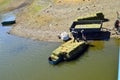 Two workers load bales of hay on boat, Studen kladenec Dam