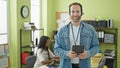 Two workers man and woman using touchpad and headphones working at the office Royalty Free Stock Photo