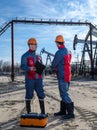 Two workers in the oilfield Royalty Free Stock Photo