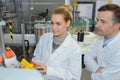 Two workers at production line in high technology plant Royalty Free Stock Photo