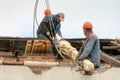 Two workers are repairing the roof of an old building. Repair of the roof, replacement of ceilings and wooden beams, installation Royalty Free Stock Photo