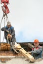 Two workers are repairing the roof of an old building. Repair of the roof, replacement of ceilings and wooden beams, installation Royalty Free Stock Photo