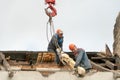 Two workers are repairing the roof of an old building. Repair of the roof, replacement of ceilings and wooden beams, installation