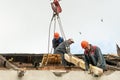 Two workers are repairing the roof of an old building. Repair of the roof, replacement of ceilings and wooden beams, installation Royalty Free Stock Photo