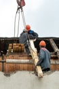 Two workers are repairing the roof of an old building. Repair of the roof, replacement of ceilings and wooden beams, installation Royalty Free Stock Photo