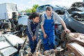 Two workers in scrap metal yard Royalty Free Stock Photo