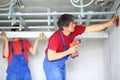 The two workers set the ceiling profile in the Royalty Free Stock Photo