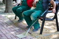 Construction workers rest on a bench after doing hard work.