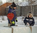 Two workers at the site of the ice camp