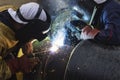 Two workers together welding big tube Royalty Free Stock Photo