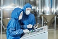 Two workers using control panel operating equipment at factory Royalty Free Stock Photo