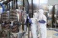 Two Workers Wearing Hazmat Suits at Chemical Factory